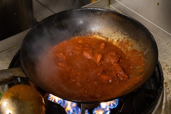 Curry being cooked in a kitchen.