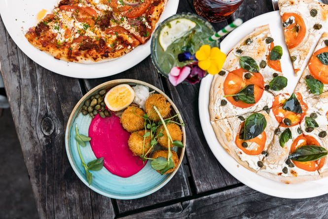 A close up of colourful plates of food on a table.