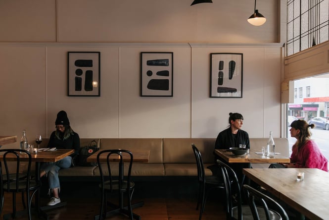 Customers sitting on a bench seat at Arden.