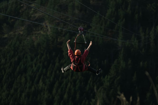 A person flying down one of the zip lines at Christchurch Adventure Park.