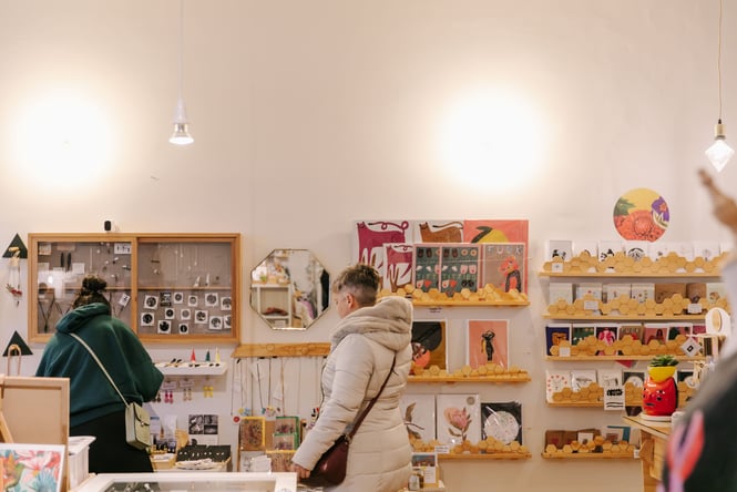 Two woman browsing at Little Beehive Co-op.