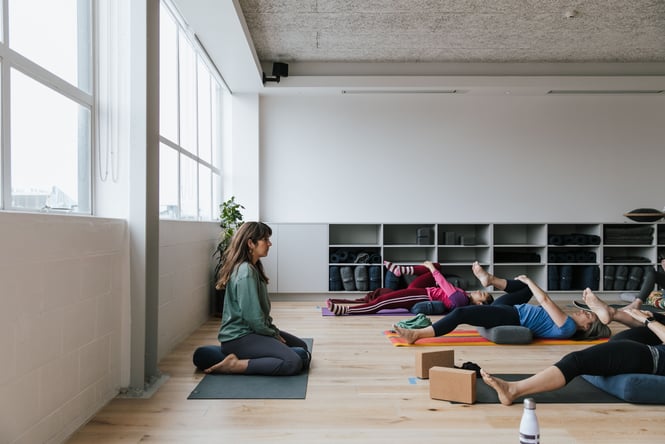 A yoga teacher taking a a class at O Studio.