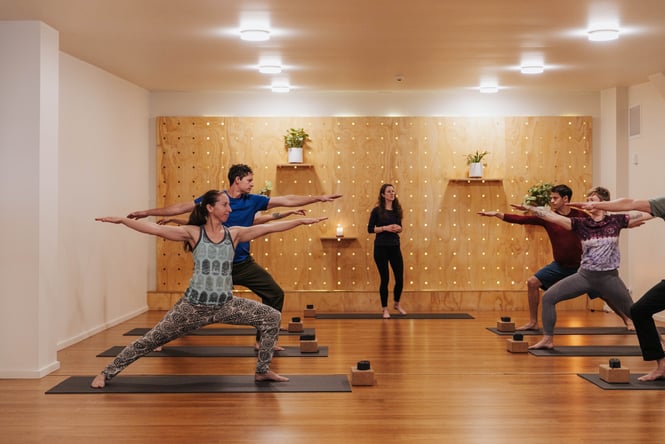 A group of yogis in warriors pose at Uprising.