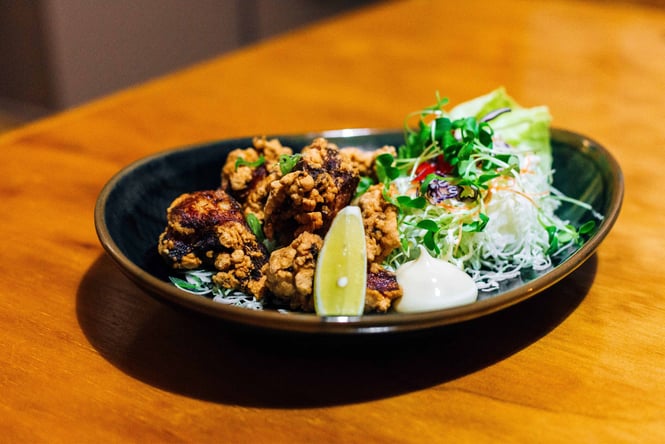 Fried chicken on a table with a side salad