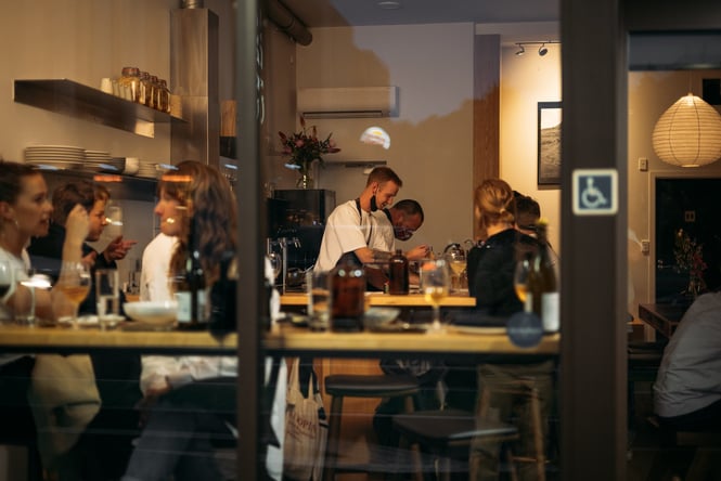 View through the window to chef's working at the bar at Londo.