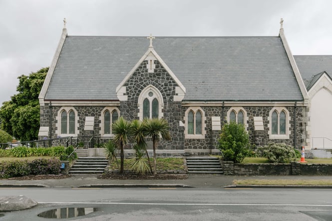 A stone church on a cloudy day.