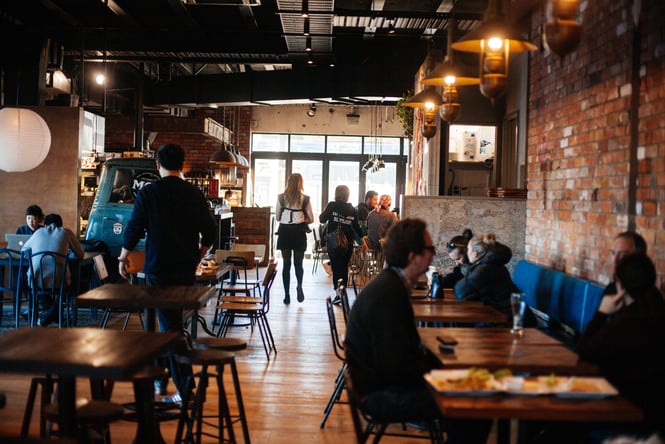 Interior view of Little High with lots of different people sitting down.