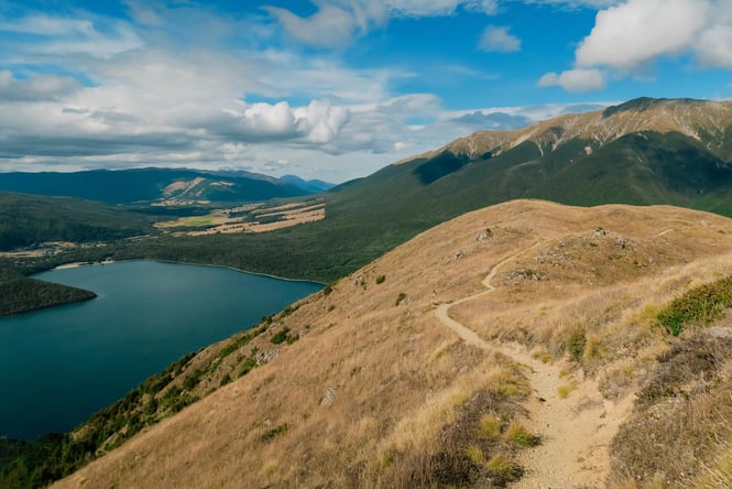 The reflective lake of Lake Rotoiti on a sunny day.