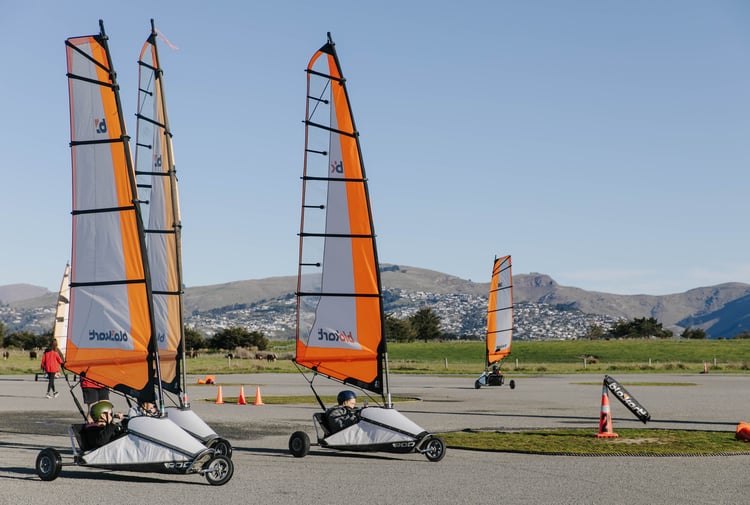 Go-karts with sails moving around a track in Christchurch.