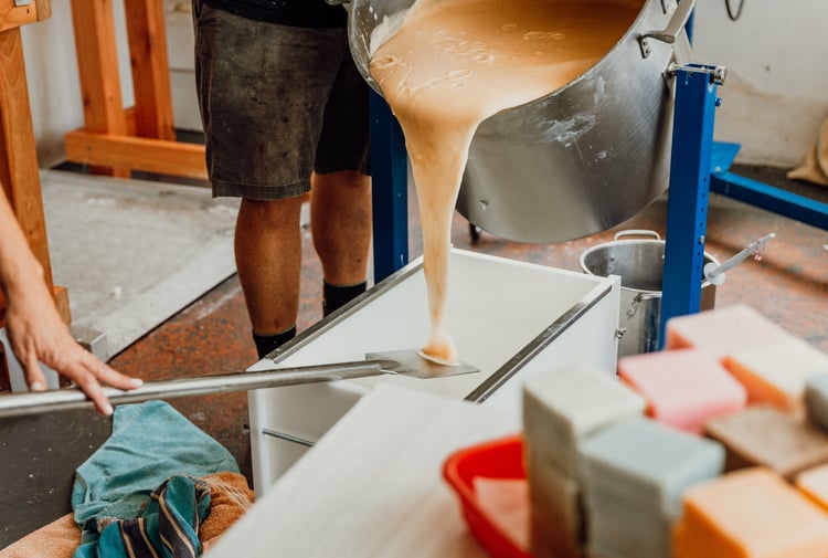 Liquid soap being poured on to a table ready for setting.