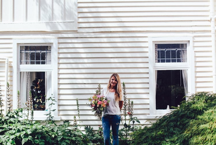 A photo of Natalie-Rose holding a bunch of flowers.