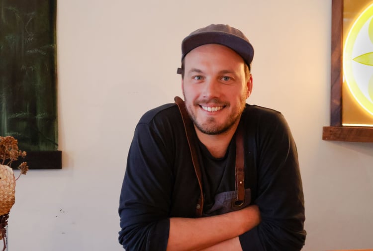 Image of the Chef Alex Davies wearing a cap.