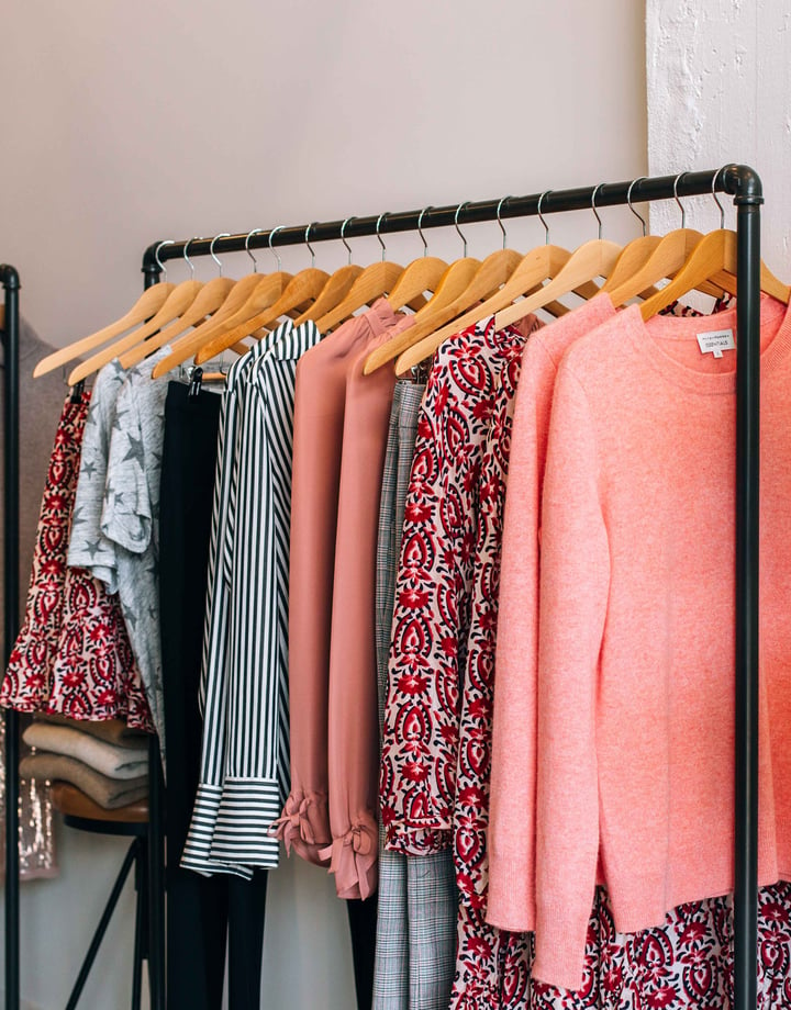 Pink clothes on racks.