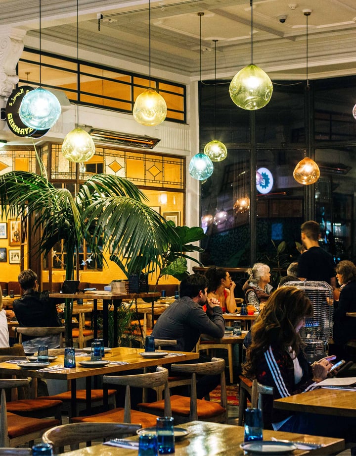 Customers dining under colourful bulbs at Gemmayze Street in Auckland.