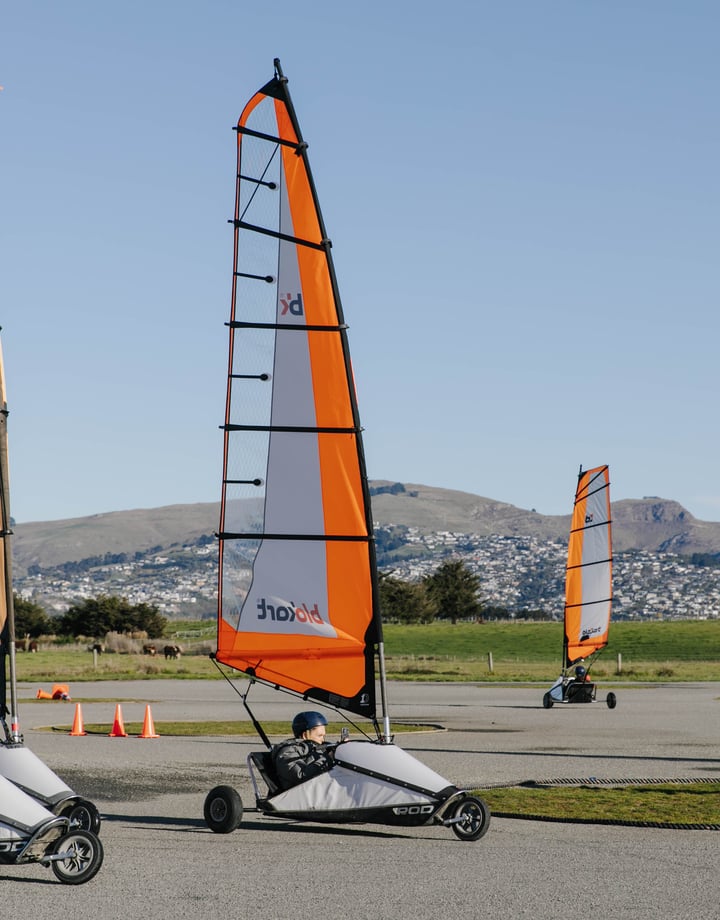 Go-karts with sails moving around a track in Christchurch.