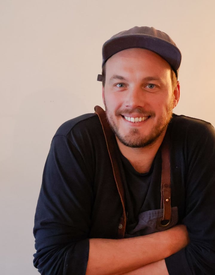 Image of the Chef Alex Davies wearing a cap.