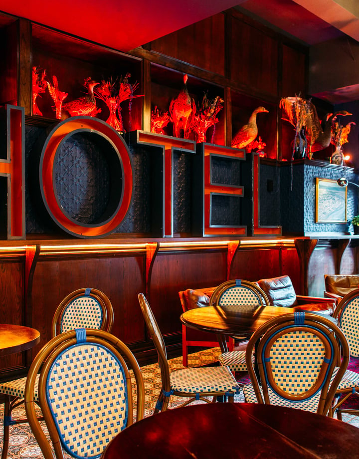 A massive red 'HOTEL' sign on a wall.