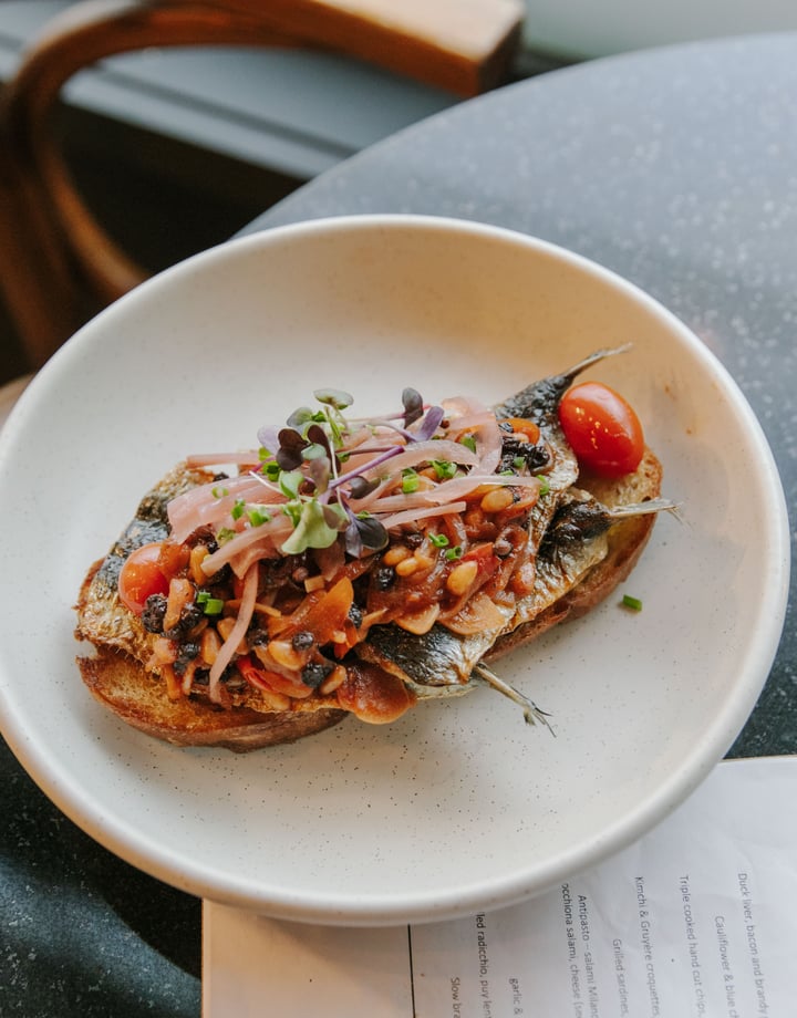 Sardines on toast on a table.