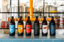 Bottles of beers lined up on a counter at Brave Brewing Hastings.