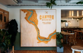 A large 'Canyon Brewing' sign on a wall.