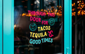 A sign promoting tacos and Mexican food.