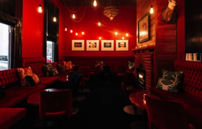 The red lit interior of Snug Lounge in New Plymouth.