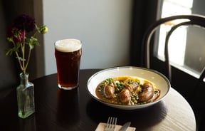 A beer and bangers and mash on a table at Victoria Free House Christchurch.