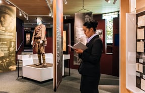 Woman reading notebook at Waikato Museum, Hamilton.