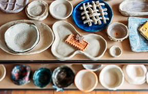 A birdseye view of pottery on shelves.
