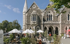 Exterior shot of the historic Arts Centre and Frances Nation Cafe in Christchurch on a hot summer's day