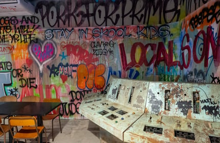 Graffitied walls inside a bar.