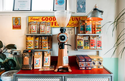 Coffee machine and bags of coffee on a colourful counter in Miss Fortune's cafe