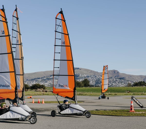 Go-karts with sails moving around a track in Christchurch.