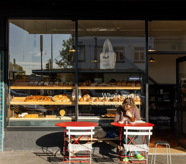 A customer dining outside Florets Bakery Auckland on a sunny day.