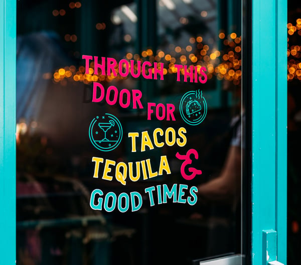 A sign promoting tacos and Mexican food.
