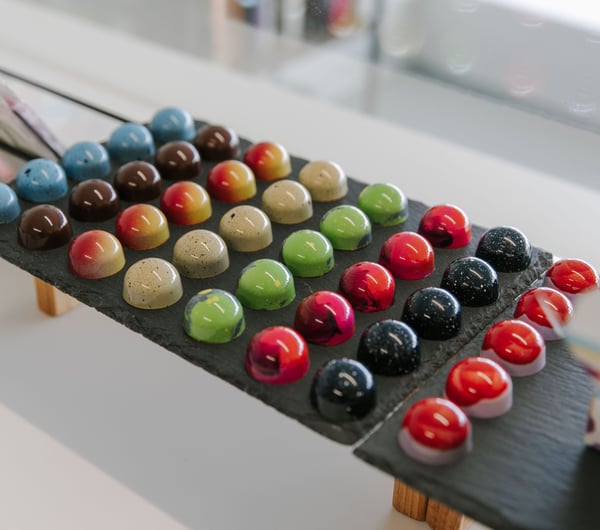 A close up of colourful chocolates on display at Mind Your Temper Christchurch.