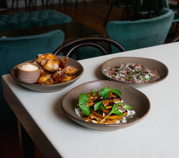 Three dishes of food on a table at Miro in the old Caffe Roma building in Christchurch.