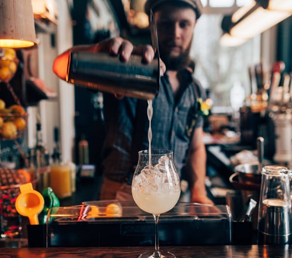 A man pouring a cocktail at OGB in Christchurch.