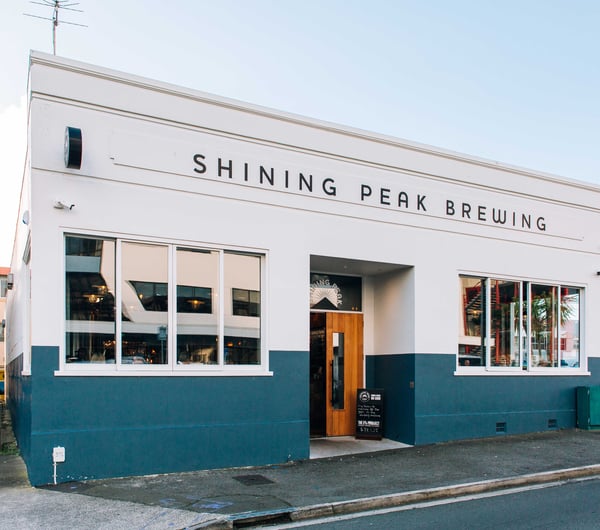 The blue and white exterior of Shining Peak Brewing in New Plymouth.