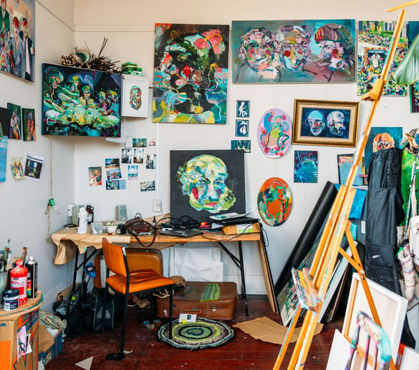 An artist's studio full of painted works of art.