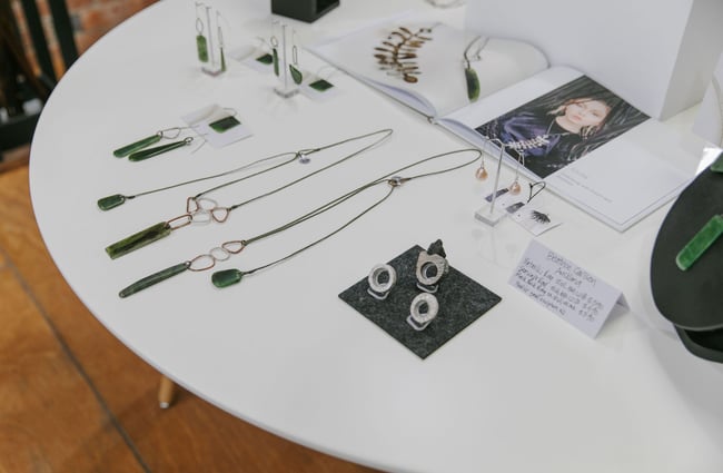 Rings and necklaces on a white table at 77 Art + Living in Fairlie.