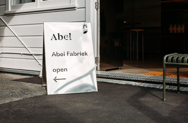 The white sign out the front of Abel perfumery.