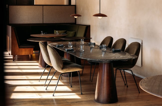 A long wooden table with chairs.