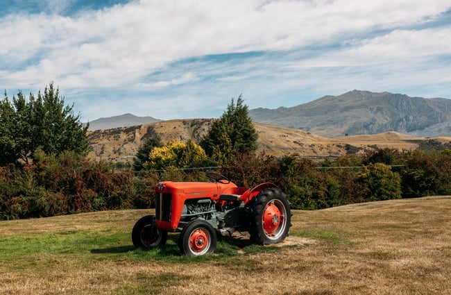 A red tractor on grass.
