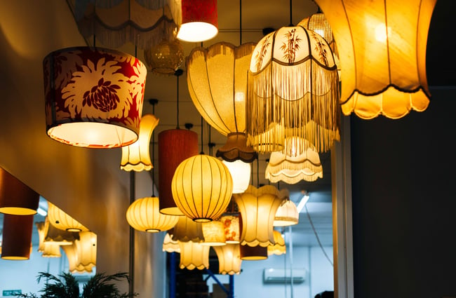 Close up of lampshades hanging from the ceiling.