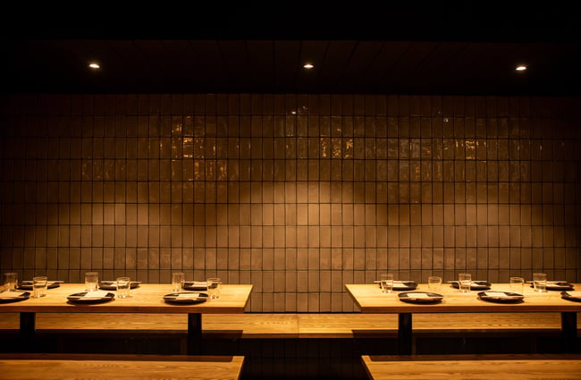 A table setting inside a dimly lit restaurant.