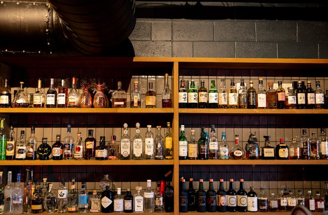 Bottles of liquor on display on shelves behind the bar at Azabu.