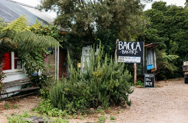 The entrance to Bacca Bakery surrounded by bush.
