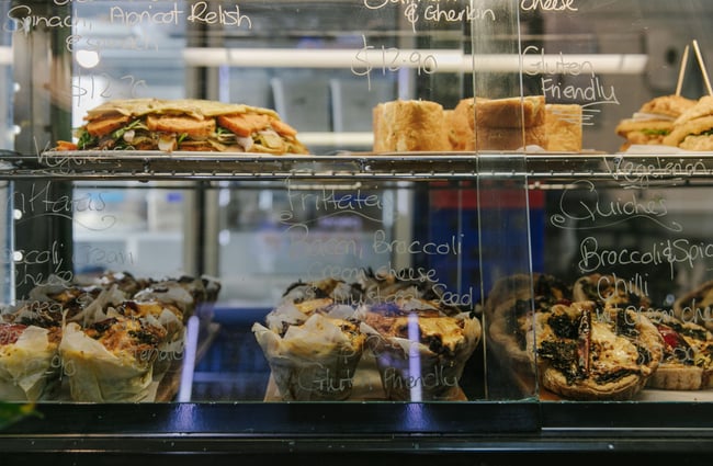 Close up of the savoury food inside the glass cabinet.