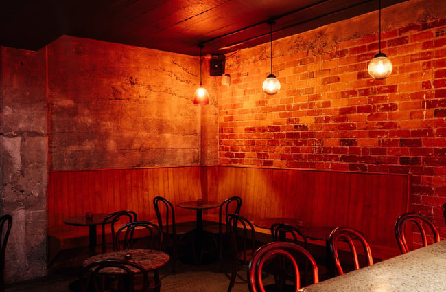 A corner of the bar lit by an orange light.